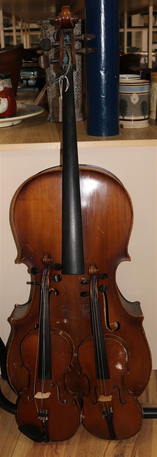 A cello and 2 violins and a box of music